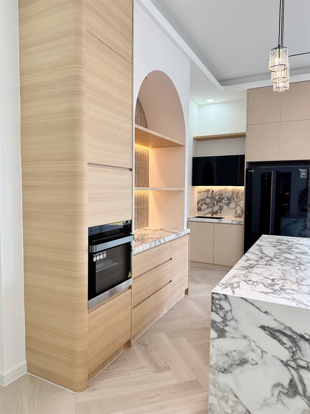 Wood-grain kitchen cabinets with built-in oven tower and marble island, Horizon Hills, Johor